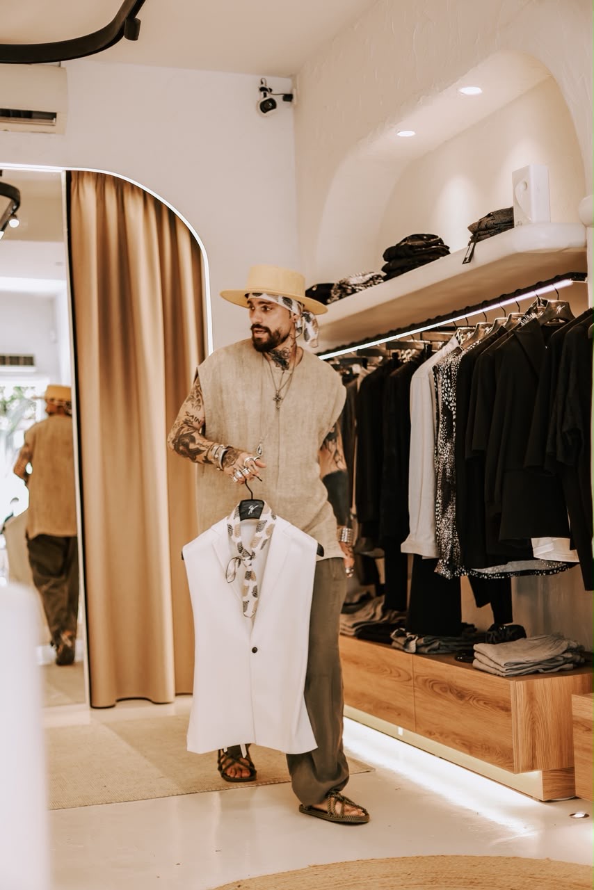Designer fitting a garment inside the Stefan boutique